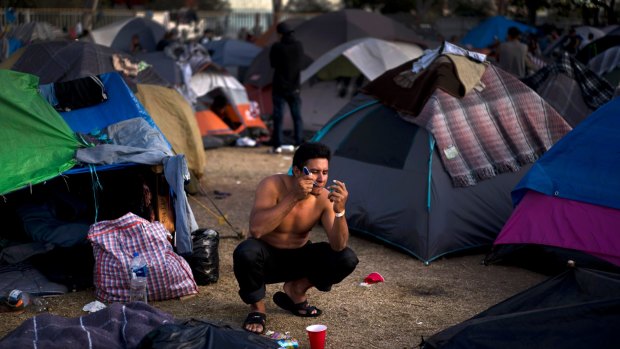 A Salvadoran migrant shaves at the Benito Juarez Sports Centre serving as a temporary shelter for Central American migrants in Tijuana in November 2018.