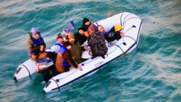 Migrants aboard a rubber boat after being intercepted by French authorities off the port of Calais on Christmas Day.