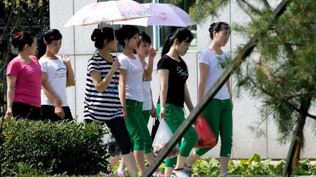 North Korean workers walk into the Hong Chao Zhi Yi garment factory in Hunchun in north-eastern China's Jilin province near the Russian border.