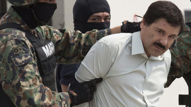 Guzman is escorted to a helicopter by Mexican security forces at Mexico's International Airport in Mexico City in February, 2014. 