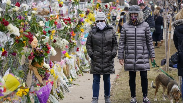 Mourners at supermarket in Boulder, Colorado, where 10 people died in a mass shooting in March. 