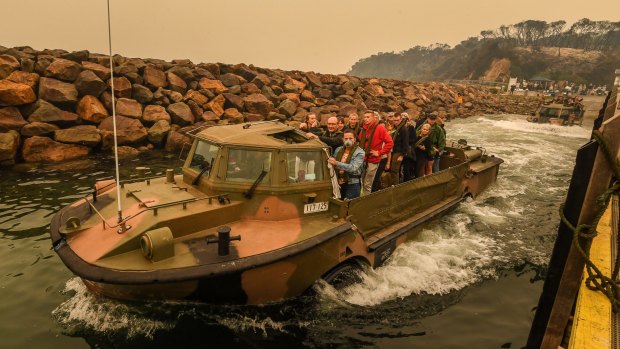 People stranded in Mallacoota are evacuated by the army to HMAS Choules on January 3. 