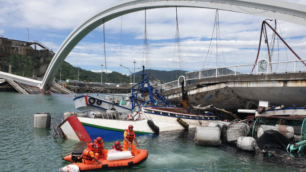 Rescuers work near the site of a collapsed bridge in Nanfangao, eastern Taiwan. 
