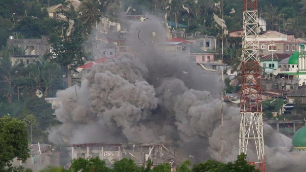 A cloud of debris rises as Philippine fighter jets bomb a suspected Islamist militant location in Marawi during a protracted battle in 2017.