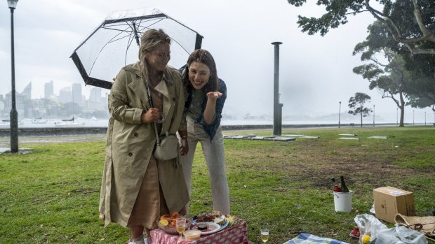 A picnic is disrupted due to heavy rain at Rushcutters Bay.