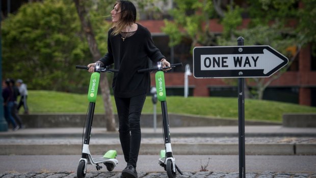 Livia Looper pushes LimeBike scooters in San Francisco, California, in May this year. 