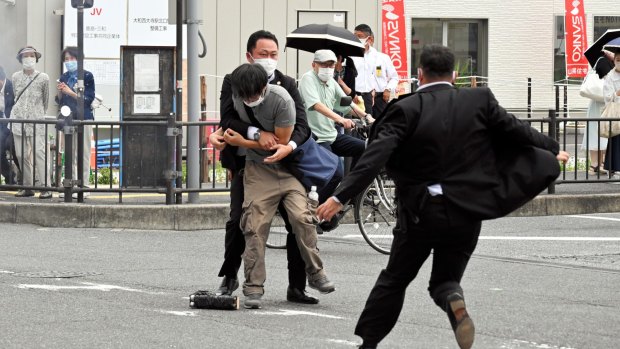 Security police tackle Tetsuya Yamagami after he shot former prime minister Shinzo Abe on Friday. 