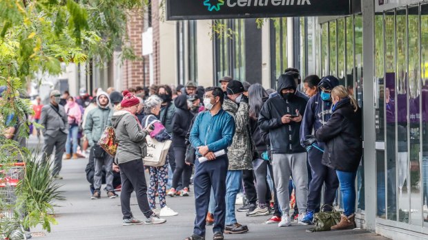 Massive lines of people lining up outside a Melbourne Centrelink office in March.