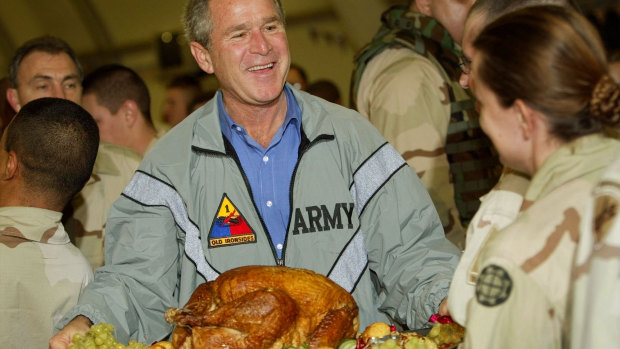 George W. Bush served turkey during a surprise Thanksgiving visit to troops in Iraq in 2003.