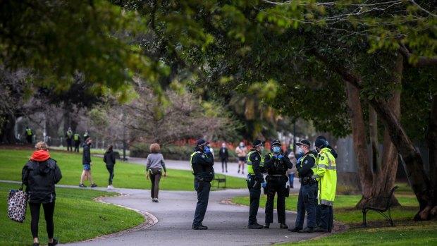 A large group of police at Fitzroy Gardens on Saturday.