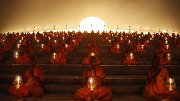 Thousands of Thai Buddhist monks chant during lantern lighting to celebrate Makha Bucha day, at the Wat Phra Dhammakaya Temple in Pathum Thani province, on the outskirts of Bangkok.