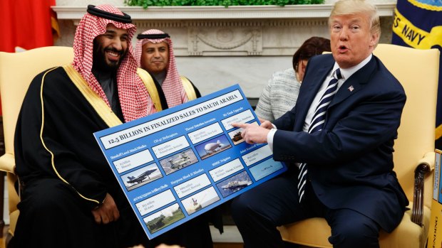 US President Donald Trump shows a chart highlighting arms sales to Saudi Arabia during a meeting with Crown Prince Mohammed bin Salman in the Oval Office in 2018.