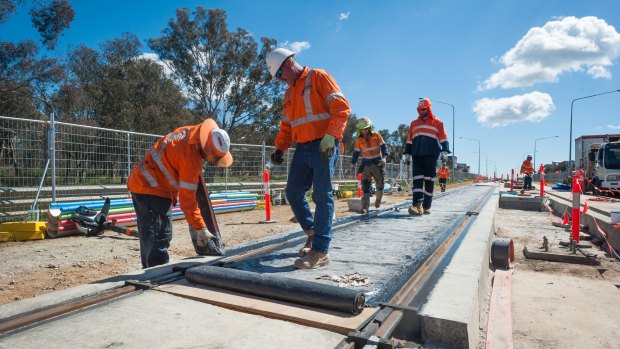 Workers construct the Canberra light rail.