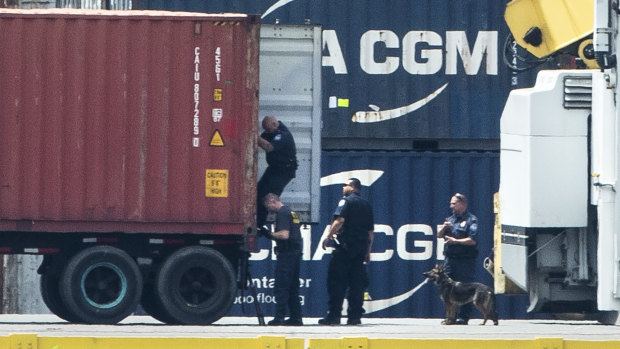 Authorities search a container along the Delaware River in Philadelphia.