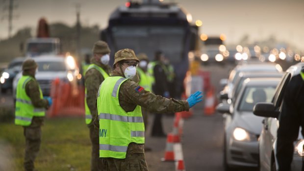 Soldiers help police at a roadside checkpoint on the Geelong Freeway as Melbourne went into lockdown in mid-July.