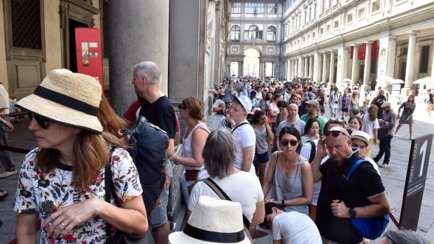 Tourists queueing to enter the Uffizi Gallery in Florence, Italy. 