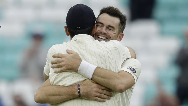 Jimmy Anderson celebrates his record-breaking wicket with friend and teammate Alastair Cook.