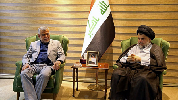 Shiite cleric Muqtada al-Sadr, right, meets with Hadi al-Amiri, commander of the Popular Mobilization Forces, in Baghdad, Iraq, on May 21, 2018.