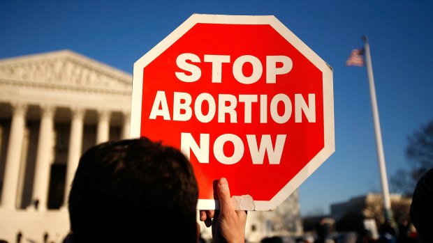 A pro-life activist holds a sign in front of the US Supreme Court as he participates in the annual March for Life event.