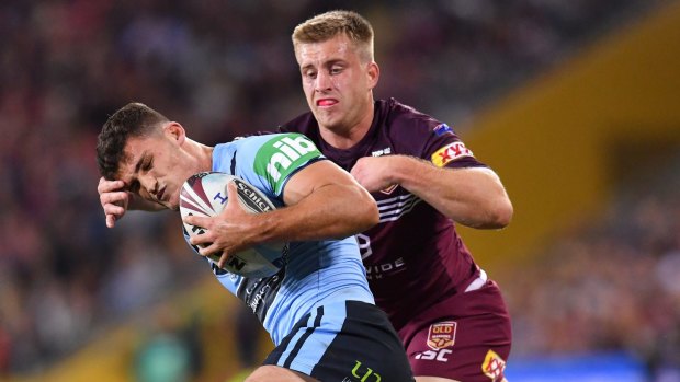 Under pressure: Nathan Cleary is tackled by Queensland playmaker Cameron Munster in Brisbane.
