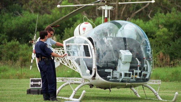 Police inspect the helicopter used to remove John Killick from Silverwater jail.