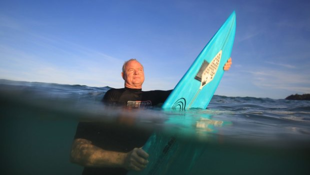Shark Shield chief executive Lindsay Lyon with the electrical shark deterrent device attached to his surfboard.