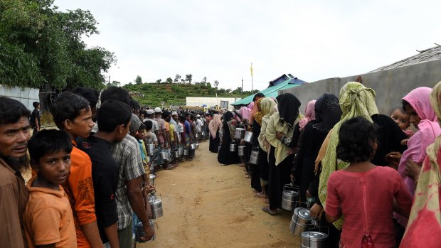 Rohingya refugees queue for a meal provided by an aid agency in Bangladesh. Some 600,000 Rohingya have fled Myanmar since the crack down in 2017.