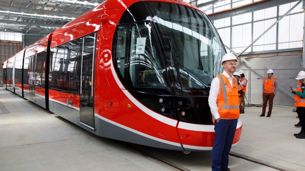 ACT chief minister Andrew Barr with Canberra's first light rail vehicle at its depot in Mitchell. 