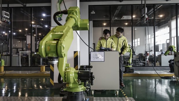 Beijing has rejected pressure from the US to roll back plans for state-led development of robotic and artificial intelligence.