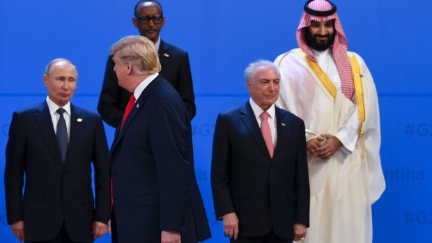 US President Donald Trump walks past Saudi Arabian Crown Prince Mohammad bin Salman, top right, Brazilian President Michel Temer, right, on his last G20 outing, in Buenos Aires last week.