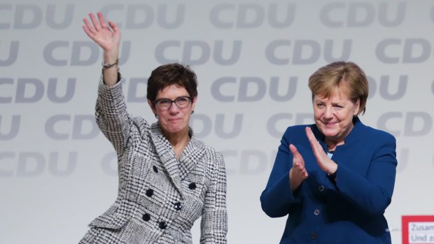 Angela Merkel, Germany's chancellor applauds Annegret Kramp-Karrenbauer, general secretary of the Christian Democrat Union in 2018. 