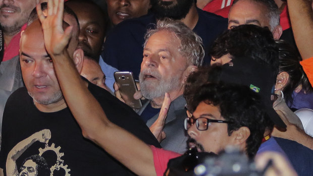 Former Brazilian president Luis Inacio Lula da Silva, centre, leaves the metal workers union headquarters before his arrest.