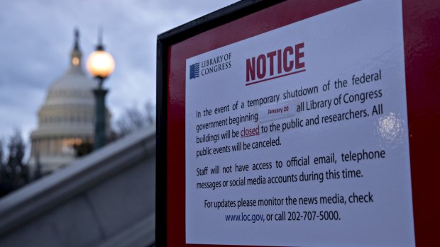 The US Capitol and a temporary shutdown sign outside the Library of Congress in Washington, DC.