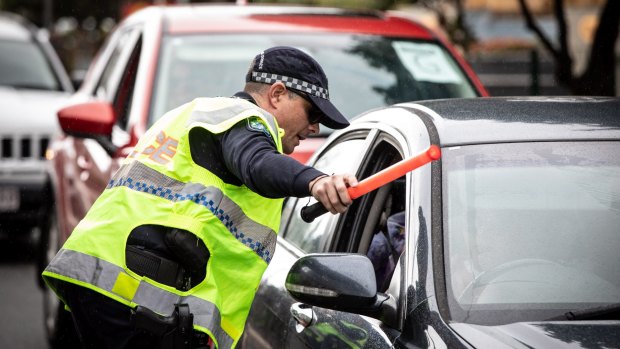 Police check vehicles for permits at a Queensland-NSW border checkpoint in Coolangatta on the Gold Coast.