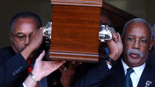 Tommie Smith (left) and John Carlos carry the coffin of Peter Norman from Williamstown Town Hall.