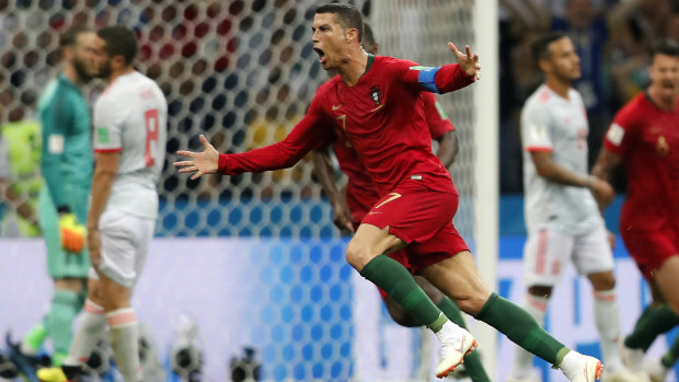 Cristiano Ronaldo wheels away in delight after scoring his third goal with a free kick.