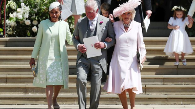 Doria Ragland, mother of the bride, Britain's Prince Charles and Camilla, Duchess of Cornwall following the wedding.