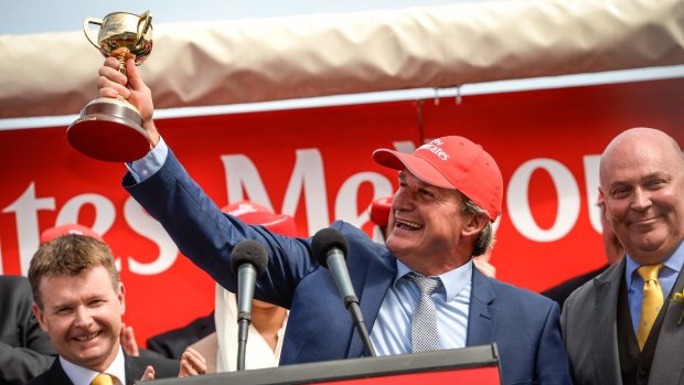 Trainer Darren Weir holds aloft his 2015 Melbourne Cup.