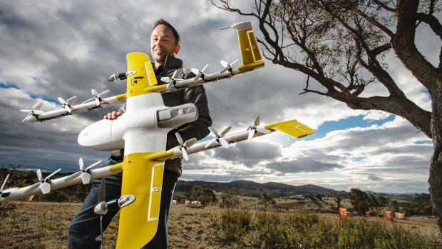 Wing's chief executive James Ryan Burgess with one of the delivery drones, which are set to fly in Canberra's northern suburbs. 