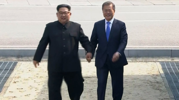 North Korean leader Kim Jong-un, left, crosses the border into South Korea, along with South Korean President Moon Jae-in for their historic face-to-face talks, in Panmunjom, in the DMZ. 