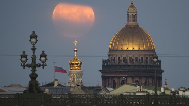 The full moon sets in the clouds over the St. Isaac's Cathedral in St. Petersburg last week.
