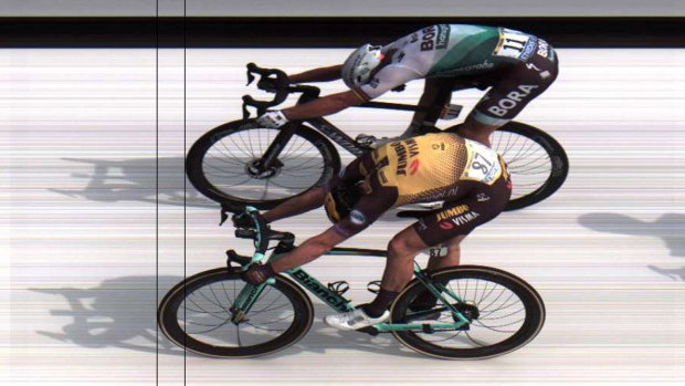 Dutchman Mike Teunissen (below) and Slovakia's Peter Sagan cross the line.