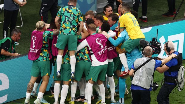Mathew Leckie and teammates celebrate after scoring Australia’s goal against Denmark.