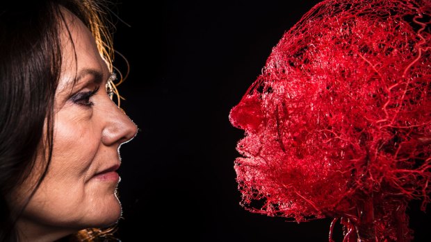 Dr Angelina Whalley, wife of the inventor of plastination, Gunther von Hagens, with a platinated head showing the configuration of blood vessels.