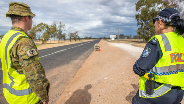 A soldier and police officer patrol Queensland's border with NSW near Hebel in central-southern Queensland.