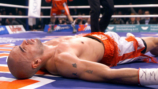 Mundine lies unconscious on the canvas after being knocked out by Sven Ottke in 2001.