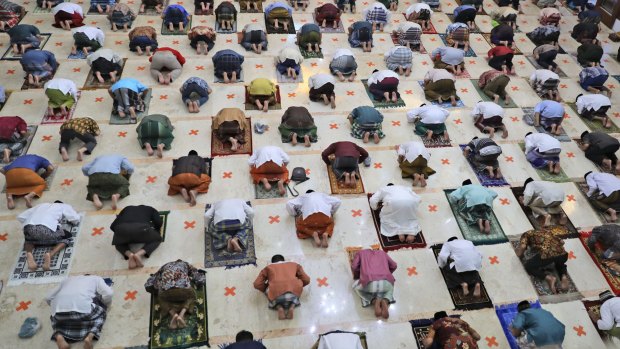 Indonesian Muslims practice social distancing while praying last month.