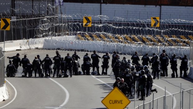 US Customs and Border Patrol officers form a line along the San Ysidro border crossing.