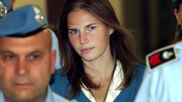 Amanda Knox is escorted by Italian penitentiary police officers to court during her 2008 trial.