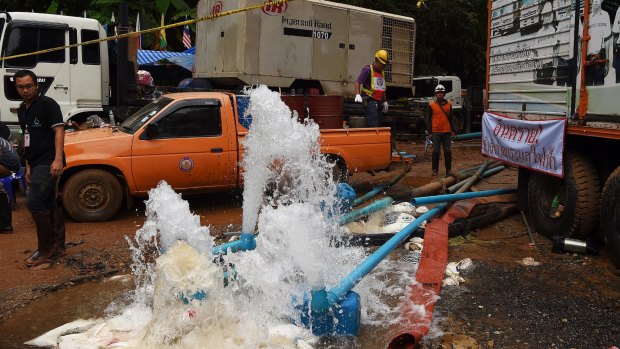 Men from the Electricity Generating Authority of Thailand overseeing the pumping of water from Tham Luang Cave.